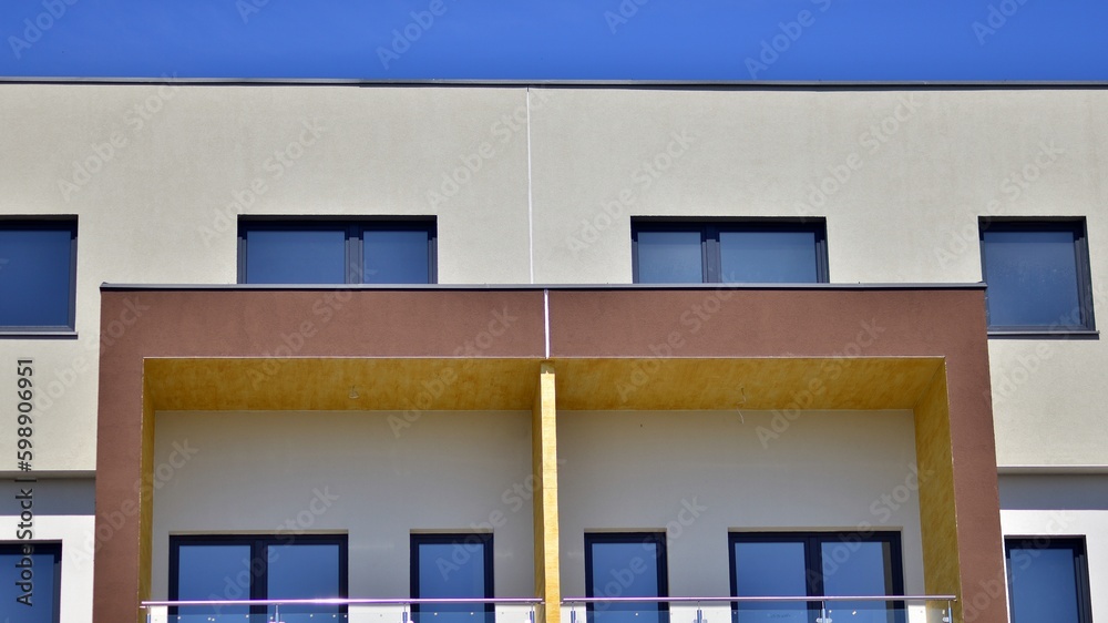 Modern apartment buildings on a sunny day with a blue sky. Facade of a modern apartment building. Contemporary residential building exterior in the daylight. Modern apartment buildings on a sunny day with a blue sky. Facade of a modern apartment building. Contemporary residential building exterior in the daylight.
