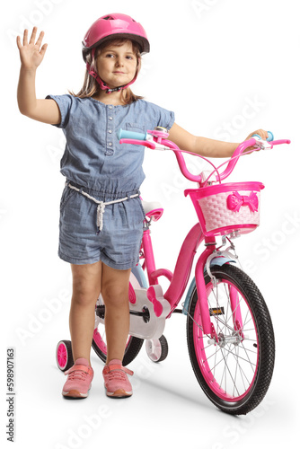 Girl with a helmet standing next to a bicycle and waving