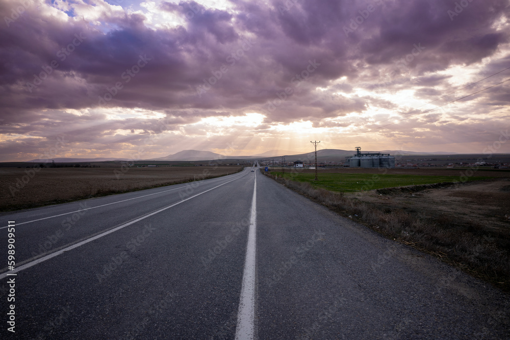 Empty highway stretching straight to the horizon Empty highway stretching straight to the horizon
