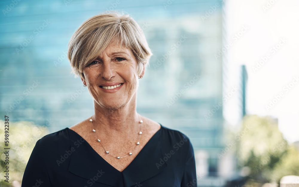 Confidence came with experience. Portrait of a confident mature businesswoman against a city background.