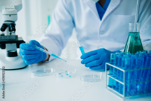 Male scientist researcher conducting an experiment working in chemical laboratory