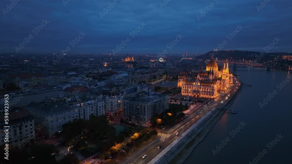 Aerial view of the illuminated Hungarian Parliament Building with the Danube river. Budapest, Hungary. Travel, tourism and European Political Landmark Destination