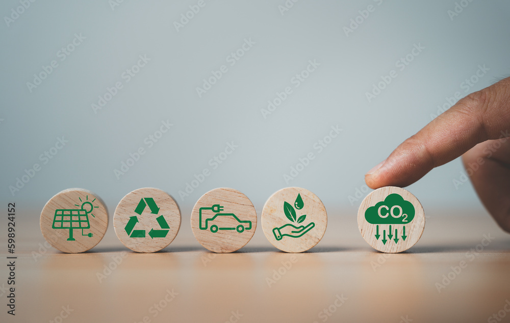 Finger rolling CO2 reducing icon to protect the environment  for decrease CO2 , carbon footprint and carbon credit to limit global warming from climate change, Bio Circular Green Economy concept. - obrazy, fototapety, plakaty 