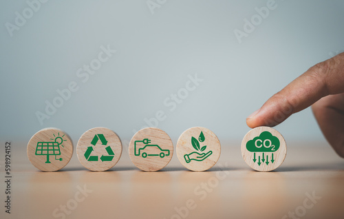 Finger rolling CO2 reducing icon to protect the environment  for decrease CO2 , carbon footprint and carbon credit to limit global warming from climate change, Bio Circular Green Economy concept.