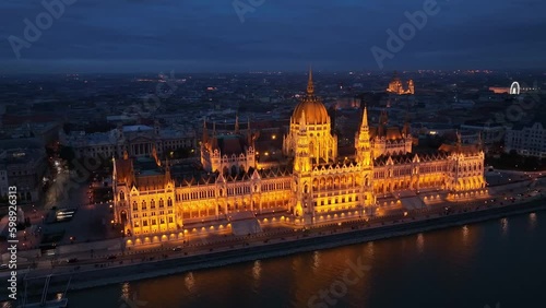 Aerial view of the illuminated Hungarian Parliament Building with the Danube river. Budapest, Hungary. Travel, tourism and European Political Landmark Destination