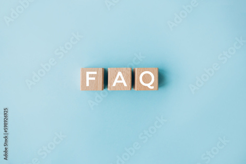 FAQ concept on wooden cubes on the blue background