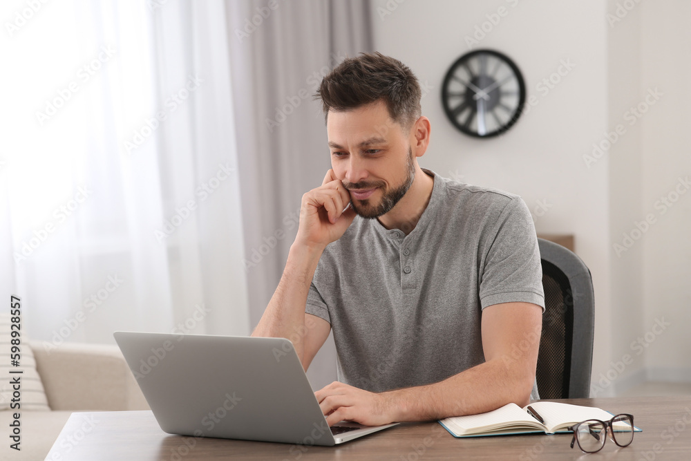 Man studying on laptop at home. Online translation course Man studying on laptop at home. Online translation course