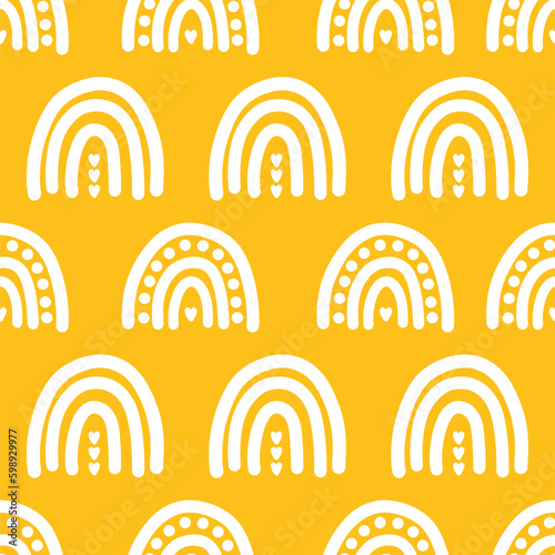 Yellow seamless pattern with rainbows and dots