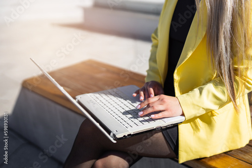 woman working on laptop outdoors in summer