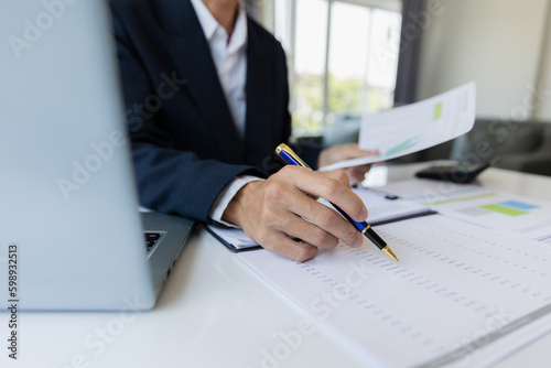 Male businessman working with calculator, business document and laptop computer notebook at room office.