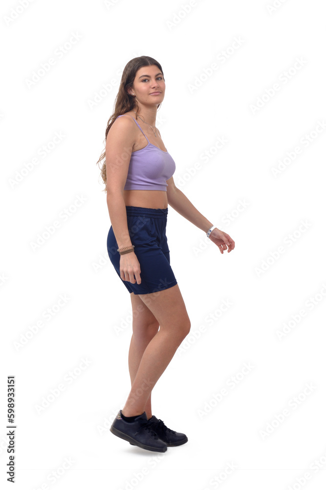 side view of a young girl walking and looking at camera on white background side view of a young girl walking and looking at camera on white background