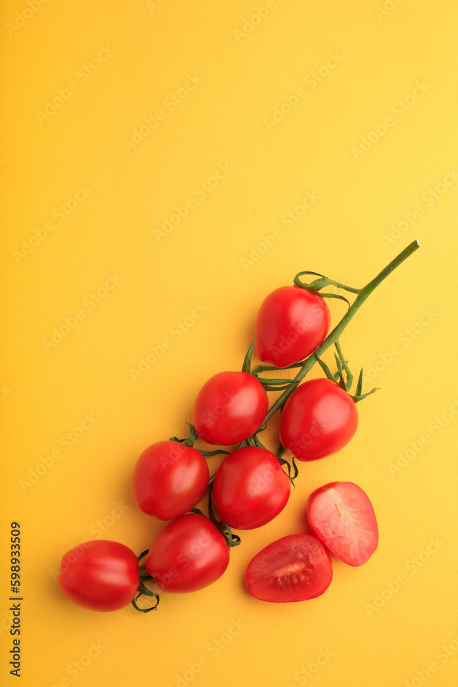 red cherry tomatoes on yellow background red cherry tomatoes on yellow background