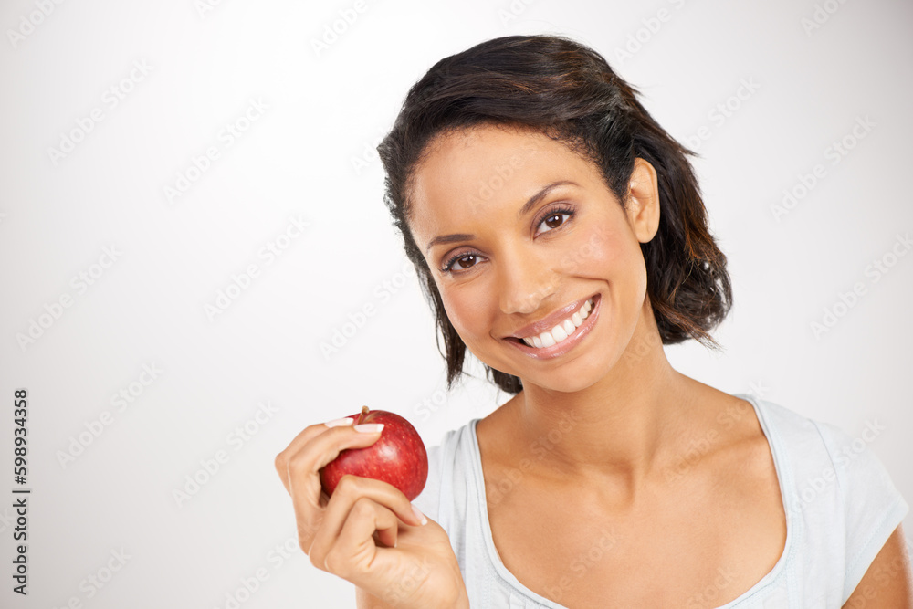 Keeping the doctor away. Portrait of a young woman enjoying a healthy snack. Keeping the doctor away. Portrait of a young woman enjoying a healthy snack.