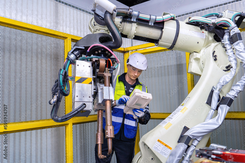 Engineer service robot welding in factory software programming operation test and commissioning Engineer service robot welding in factory software programming operation test and commissioning