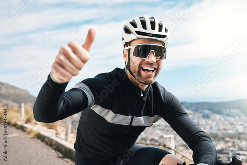 What an awesome ride. a handsome mature man gesturing thumbs up while cycling outdoors. photo