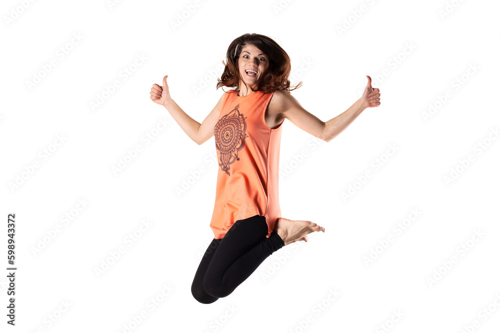happy brunette girl in orange outfit jumping in the air against white background happy brunette girl in orange outfit jumping in the air against white background