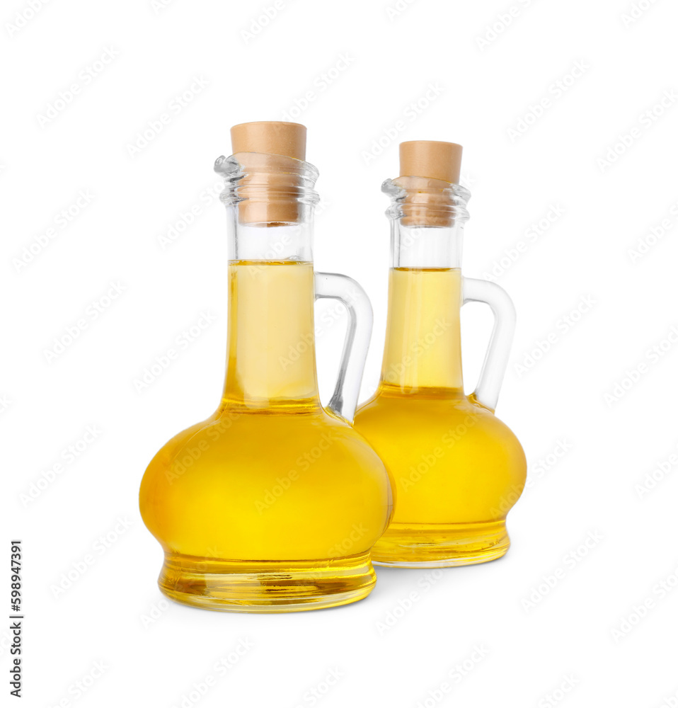 Glass jugs of cooking oil on white background Glass jugs of cooking oil on white background