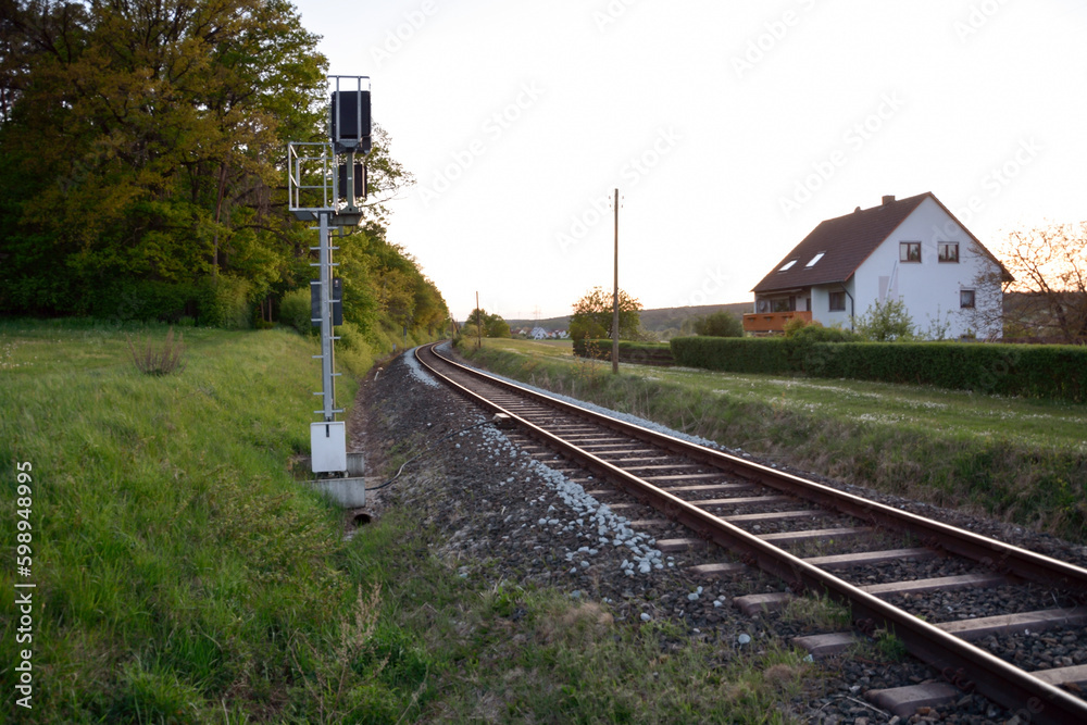 Fototapeta premium In the future, the railway tracks run between the forest and the house