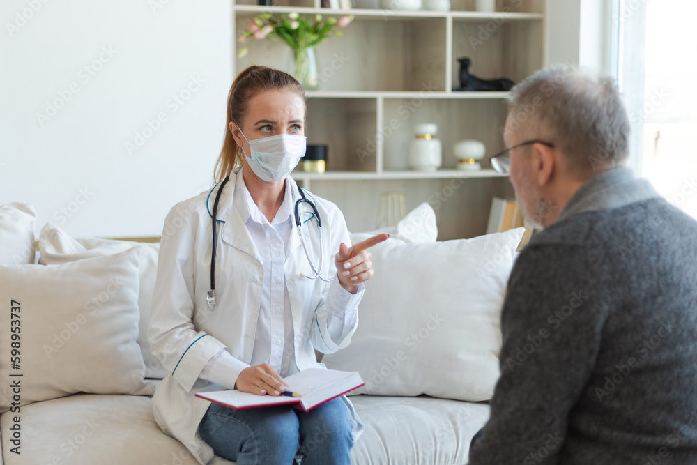 Fototapeta premium Female doctor examining older senior man in doctor office or at home. Old man patient and doctor have consultation in hospital room. Medicine healthcare medical checkup. Visit to doctor