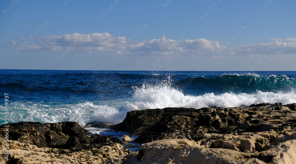 Blue sea wave and white foam and splash. Stone beach on island of Malta, no sandy beach. Summer holiday border frame concept. Tropical island vacation backdrop. Tourist travel banner design template.
