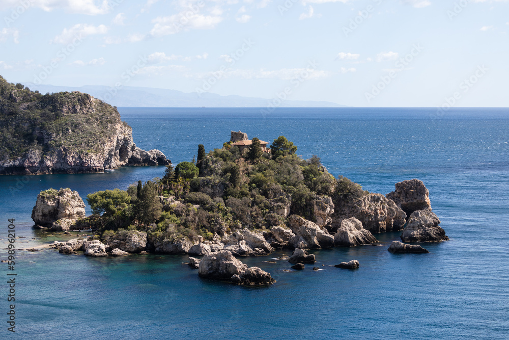 Beautiful rocky island in Taormina, Sicily coast in Italy with deep blue sea