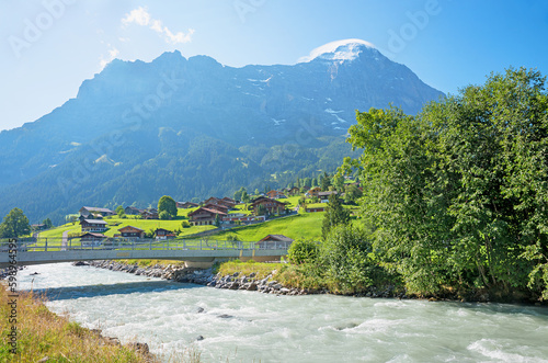 Schwarze Lutschine River with bridge, Grindelwald tourist resort switzerland and alps photo