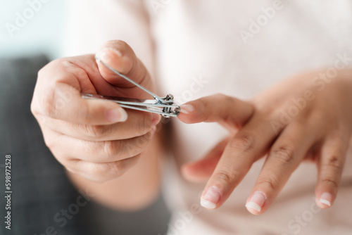 Woman cutting fingernails using nail clipper  Healthcare  Beauty Concept.