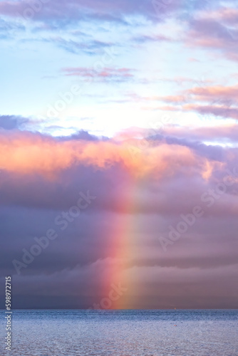 Bright colorful rainbow in the sky over the Pacific Ocean - Vancouver