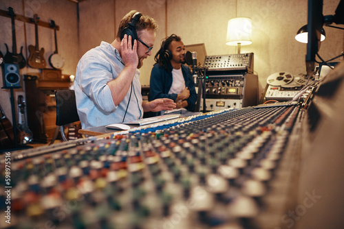 Producer and singer working together during a recording studio session