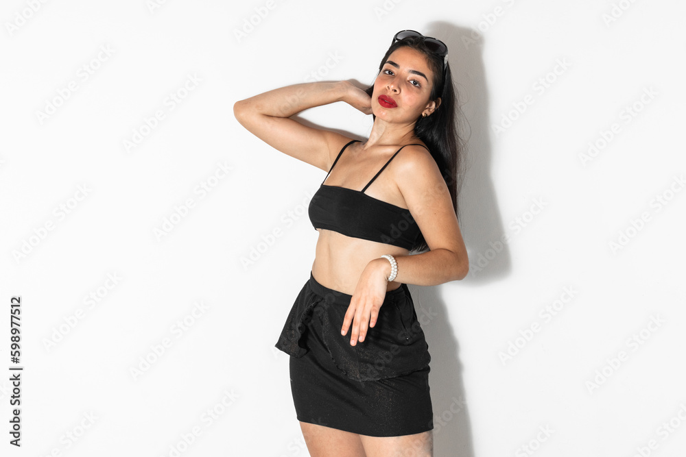 portrait of beautiful brown-skinned latina woman posing and looking straight ahead, on a white background