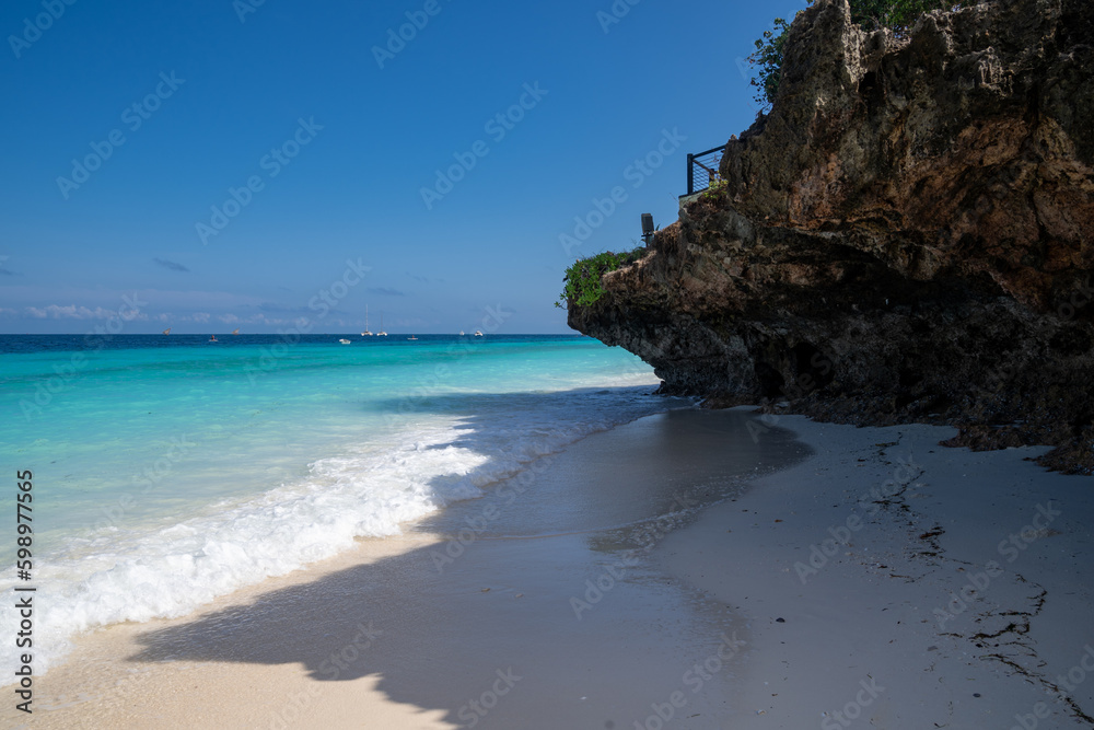 Beautiful rock formation on the shoreline of Zanzibar, Tanzania as an ocean wave rolls in Beautiful rock formation on the shoreline of Zanzibar, Tanzania as an ocean wave rolls in