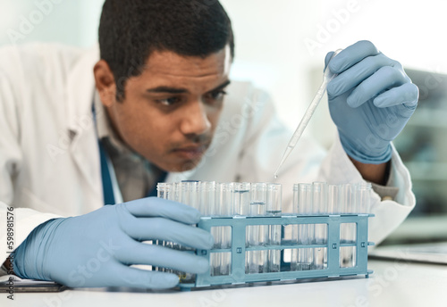 Working with caution. a young scientist working with samples in a lab.