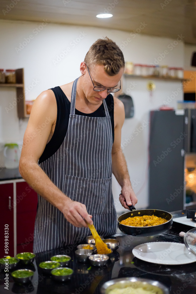 Obraz na plátně Man Preparing traditional indian food