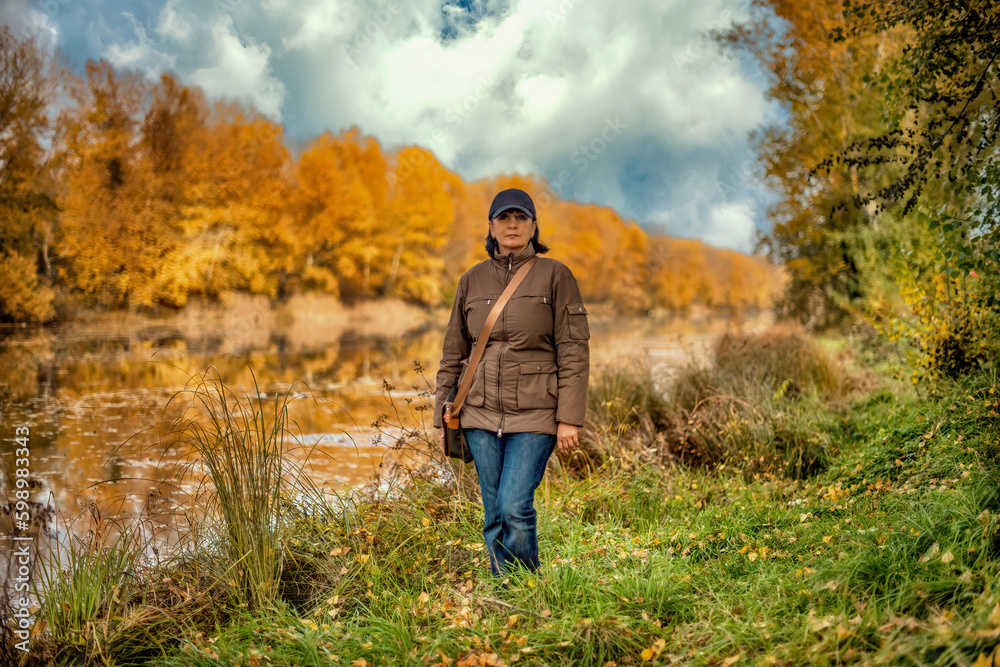 A young woman in a forest on background of the river. A young woman in a forest on background of the river.