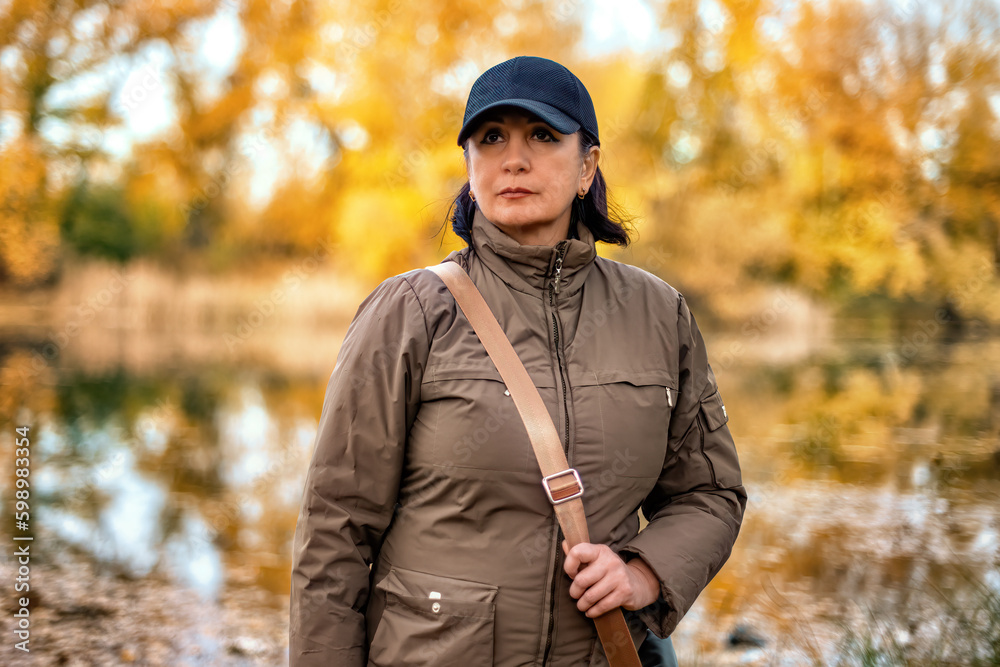 A young woman in a forest on background of the river.