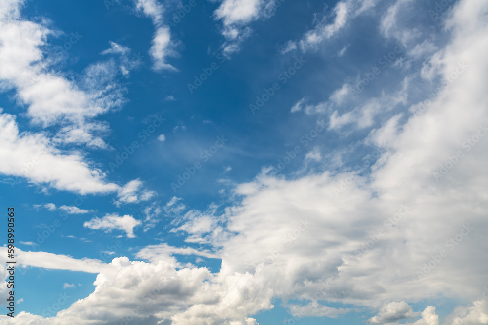 Beautiful fluffy clouds on the blue sky. Sky clouds background.