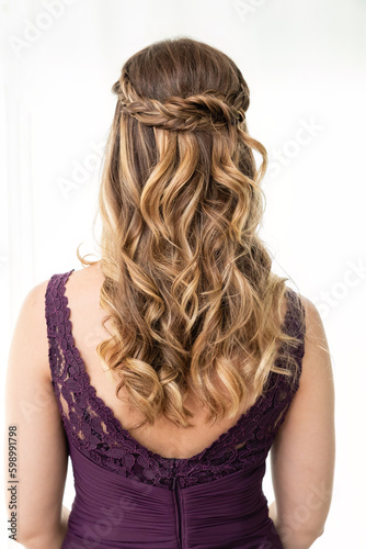 Rear view of blond woman showing hairstyle against white background