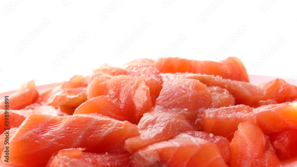 red fish slices, rotation in circle. salmon slices Turning. selective focus. sprinkle the trout with salt and pepper. place for text red fish slices, rotation in circle. salmon slices Turning. selective focus. sprinkle the trout with salt and pepper. place for text