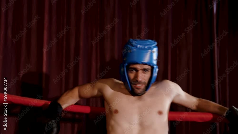 Caucasian male boxers wearing headgear and gloves are punched until