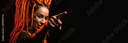 Portrait of a woman with dark orange dreadlocks pointing her index finger, banner on black background, generative ai illustration © NAITZTOYA