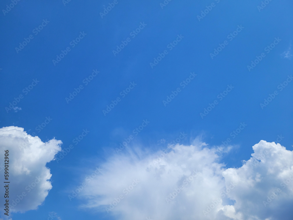 Deep blue sky with white clouds of various shapes. Clean air and the freshness of a new day. Beautiful view of clear sky, natural background. Copy space. Artificial noise and graininess. Soft focus. Deep blue sky with white clouds of various shapes. Clean air and the freshness of a new day. Beautiful view of clear sky, natural background. Copy space. Artificial noise and graininess. Soft focus.