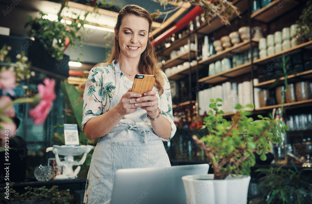 Welcome to the 21st century. an attractive young businesswoman standing in her floristry and using her cellphone to photograph her flowers. Welcome to the 21st century. an attractive young businesswoman standing in her floristry and using her cellphone to photograph her flowers.