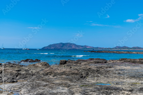 A view past the rocky beach out into the bay at Tamarindo in Costa Rica in the dry season © Nicola