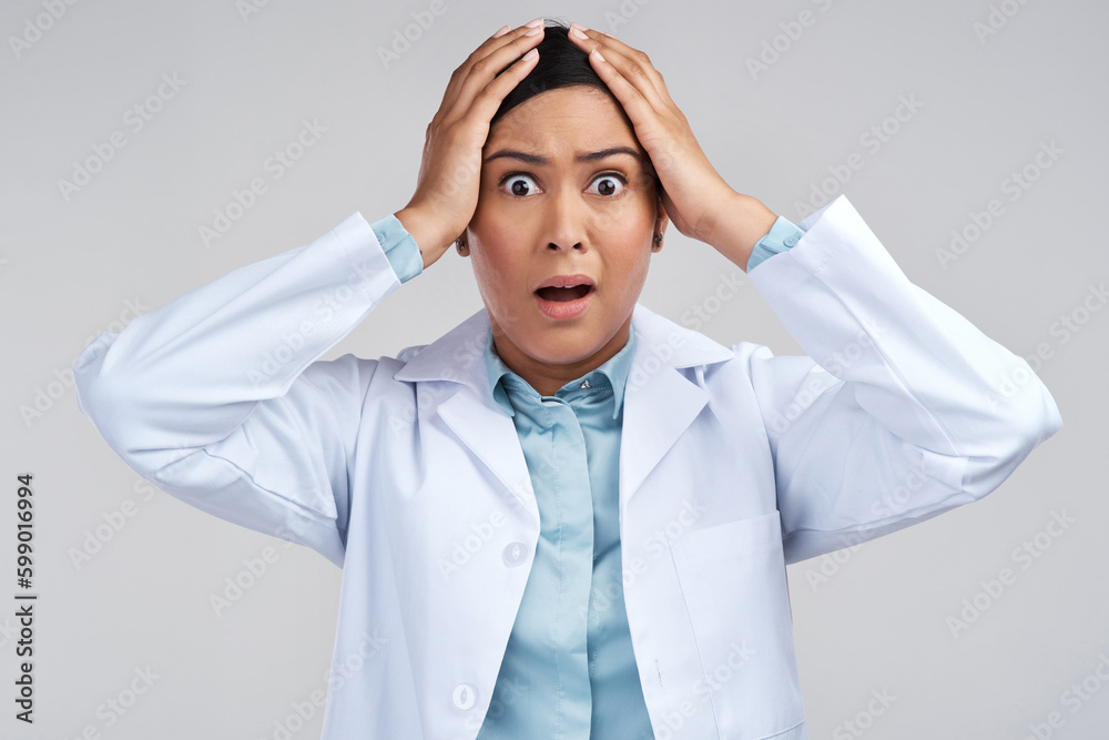 Oh no. Cropped portrait of an attractive young female scientist looking shocked in studio against a grey background. Oh no. Cropped portrait of an attractive young female scientist looking shocked in studio against a grey background.