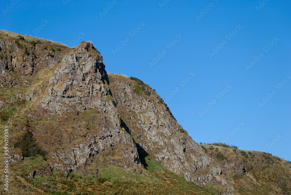The dramatic Volcanic Sea Cliffs behind the Beach of St Cyrus on the National Nature Reserve on the East Coast of Scotland. The dramatic Volcanic Sea Cliffs behind the Beach of St Cyrus on the National Nature Reserve on the East Coast of Scotland.