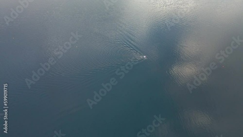 4K Aerial Drone video of Swimmer in Lake Placid. Cloud reflection visible