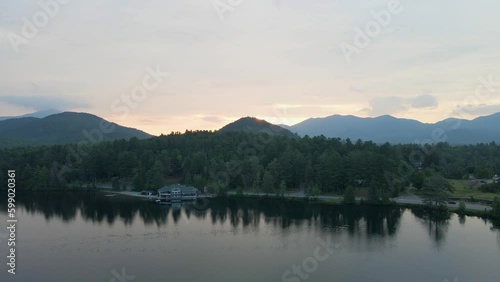 4K Aerial Drone video of Lake Placid at Sunrise with Mountains and Swimmer during Summer