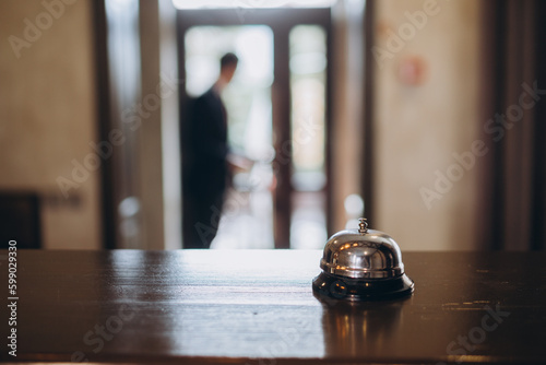 Arrival at the hotel. Reception desk with a bell in the hotel lobby.