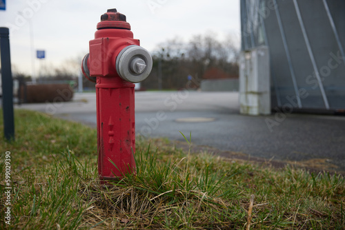 Old red fire hydrant in wroclaw poland street. Fire hidrant for emergency fire access photo