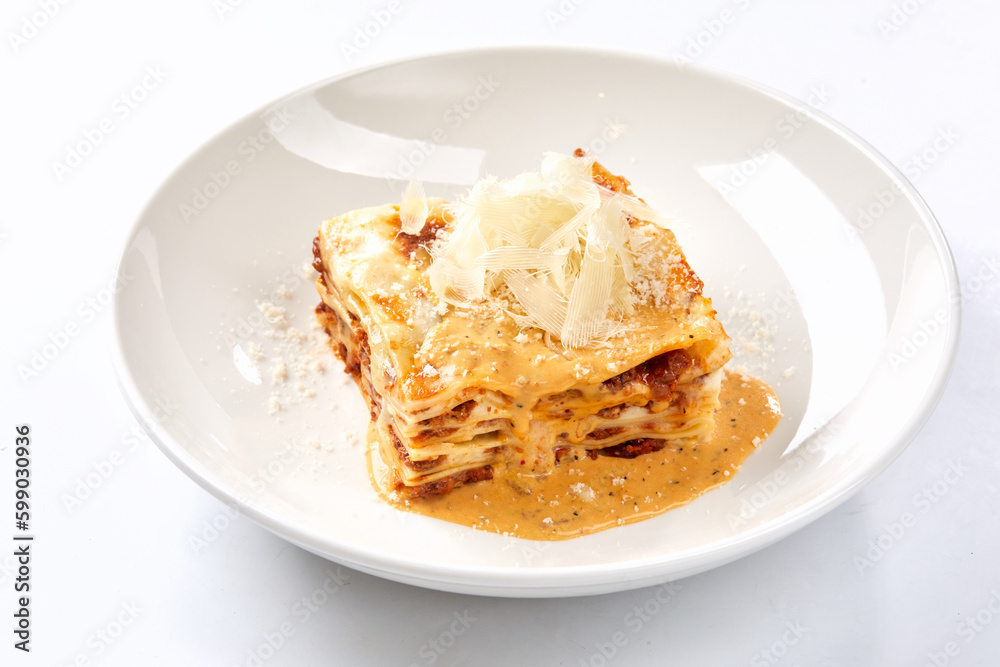 Traditional lasagna with bolognese sauce topped with basil leaves Traditional lasagna with bolognese sauce topped with basil leaves